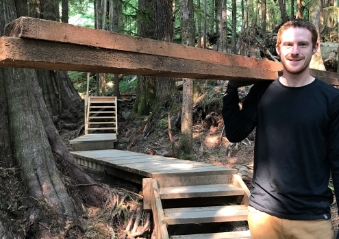 AFA Boardwalk Co-odinator TJ Watt carries materials along the new trail.