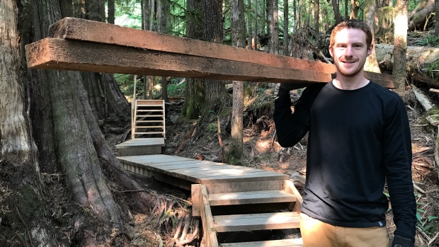 AFA Boardwalk Co-odinator TJ Watt carries materials along the new trail.