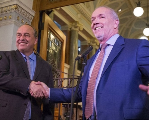 B.C. Green Party Leader Andrew Weaver and B.C. NDP Leader John Horgan shaking hands on May 29-2017