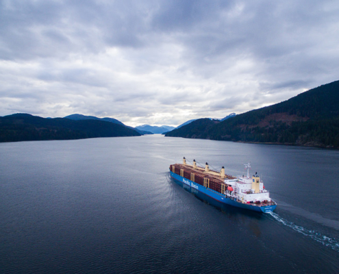 A ship loaded with raw logs leaves the Alberni Inlet on Vancouver Island.
