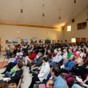About 200 people listening intently as renowned forest ecologist Andy MacKinnon presents about old-growth forests vs. second-growth tree plantations