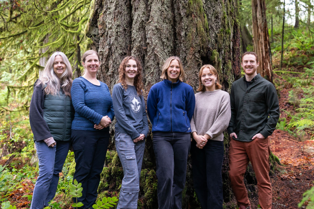 The six members of AFA staff stand beside each other in front of an ancient Doulas-fir tree.